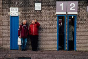 2 men standing outside Burnley football club