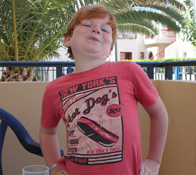 Boy wearing a red New York Hot Dogs t-shirt
