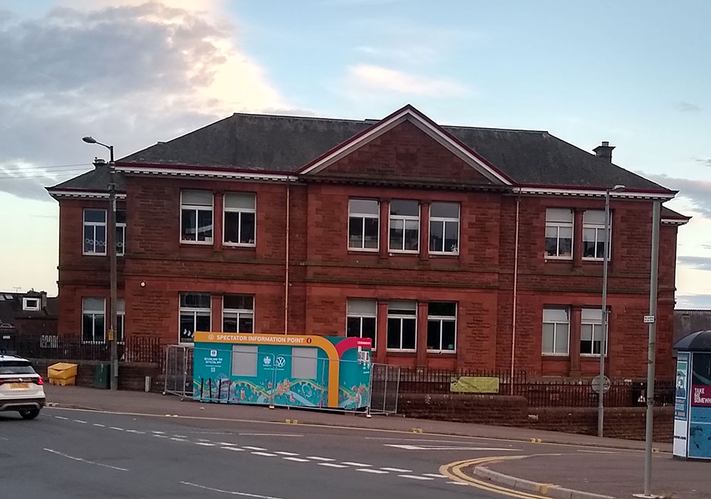 A Victorian school building on a street.