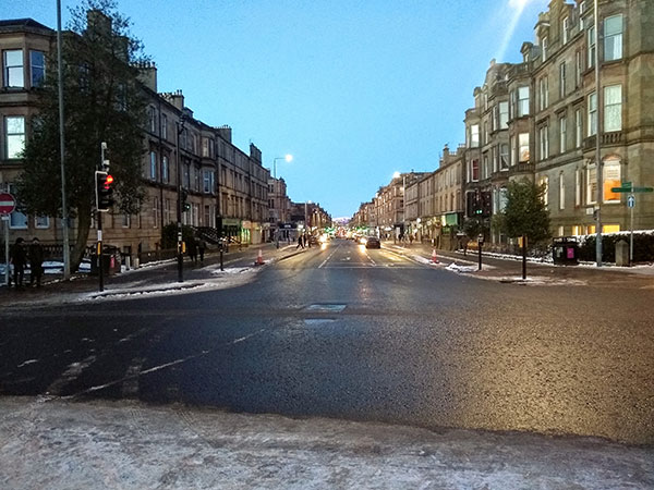 A road in Glasgow lined by tenements on either side.